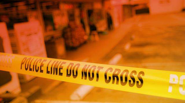 Police tape blocks entrance to a convenience store in San Luis Obispo County.